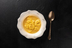 tagAlt.italian tortellini served with broth, shot from above
