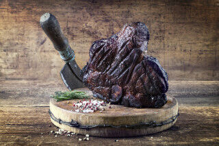 tagAlt.Traditional Italian wagyu bistecca alla Fiorentina roast beef with salt and pepper on a rustic old wooden board