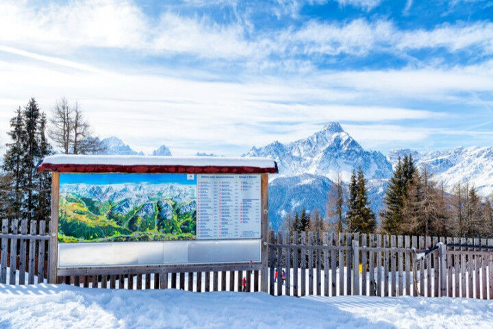 Information sign and map of the Dolomiti with Trentino Alto Adige`s peaks in the background, San Candido. Italy