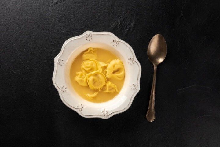 italian tortellini served with broth, shot from above_451668763125