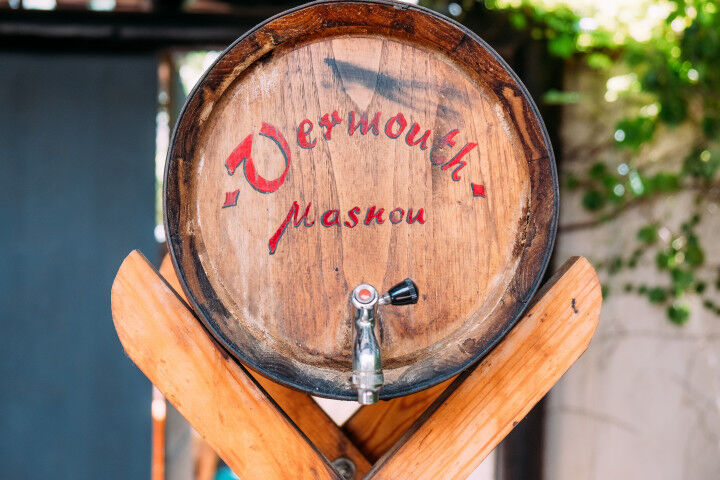 Traditional vermouth wooden barrel in outdoors spanish house during sunny summer day