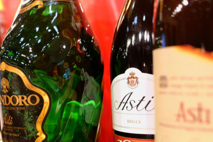 Turin, Piedmont, Italy. -10-26-2009- Fair `Wine show` detail of bottles of white sparkling wine Asti Spumante_2022010110